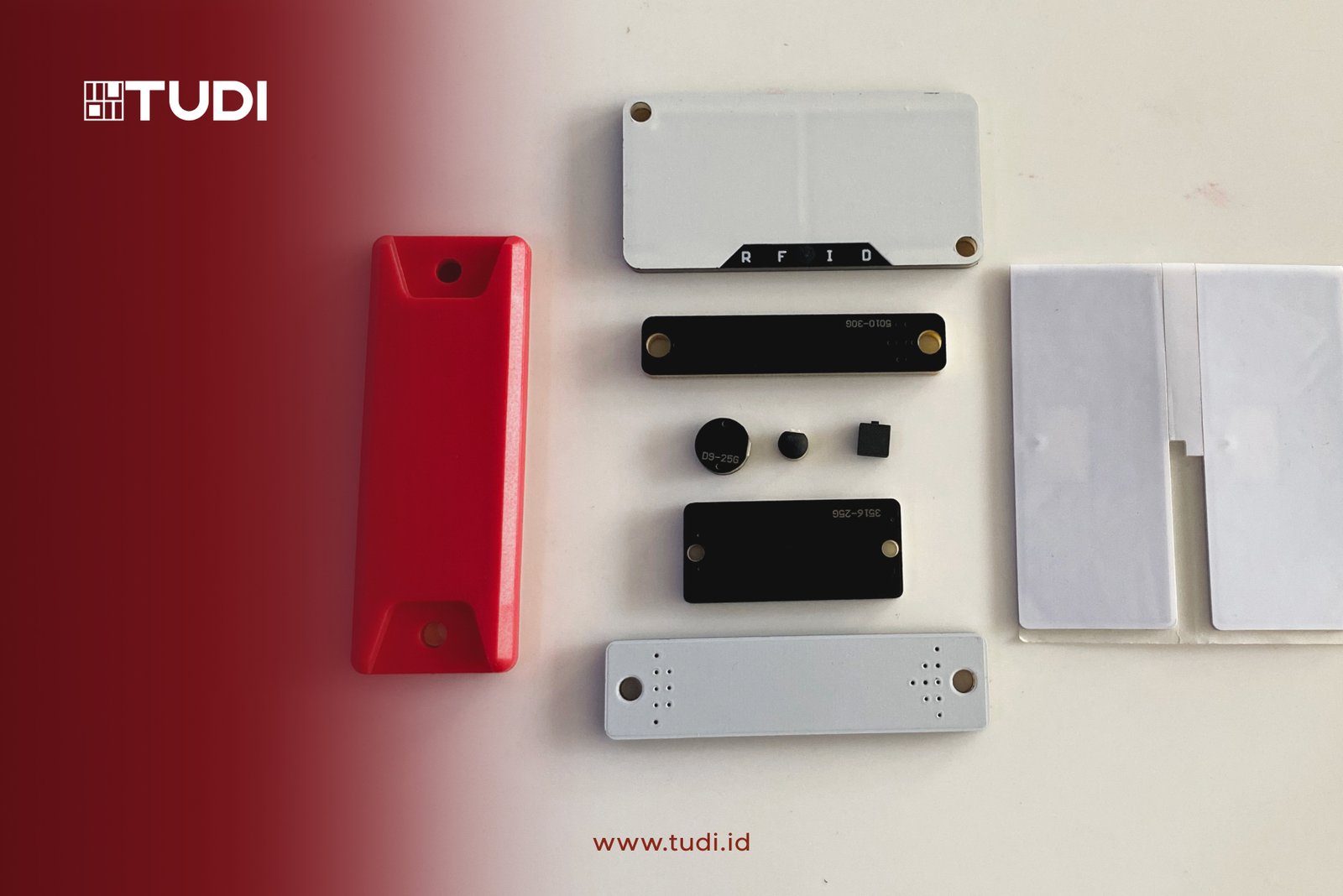 Red and white TUDI RFID components on a white background. Text: "TUDI" and "www.tudi.id" in red. Minimalist and technical layout.