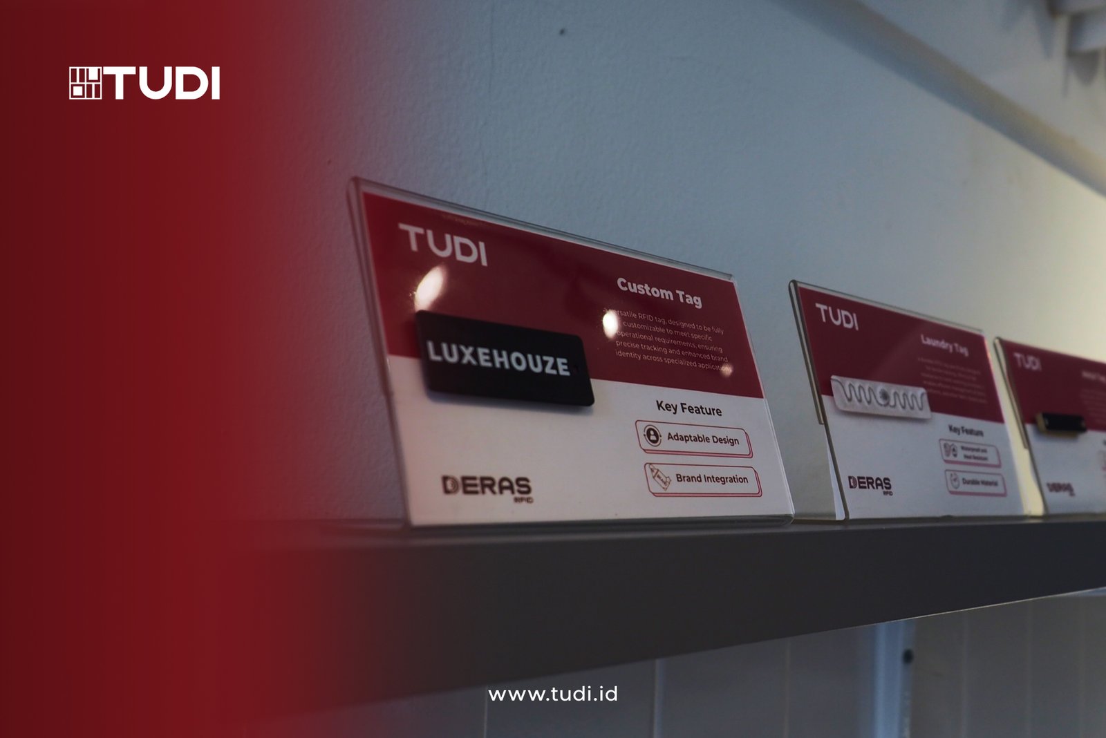 Display of labeled TUDI RFID tags on a shelf, featuring Luxehouze custom tag. Red and white theme with text on features, including brand integration.